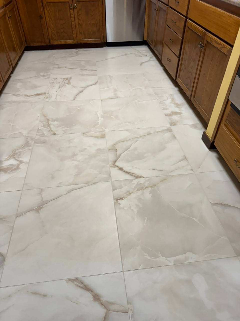 Calacatta-style porcelain tile floor in kitchen