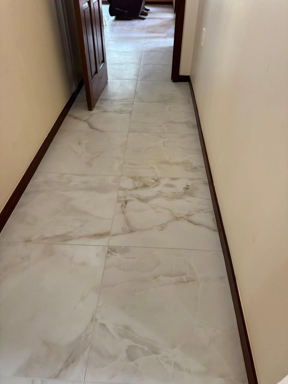 Marble-look tile flooring running down a hallway