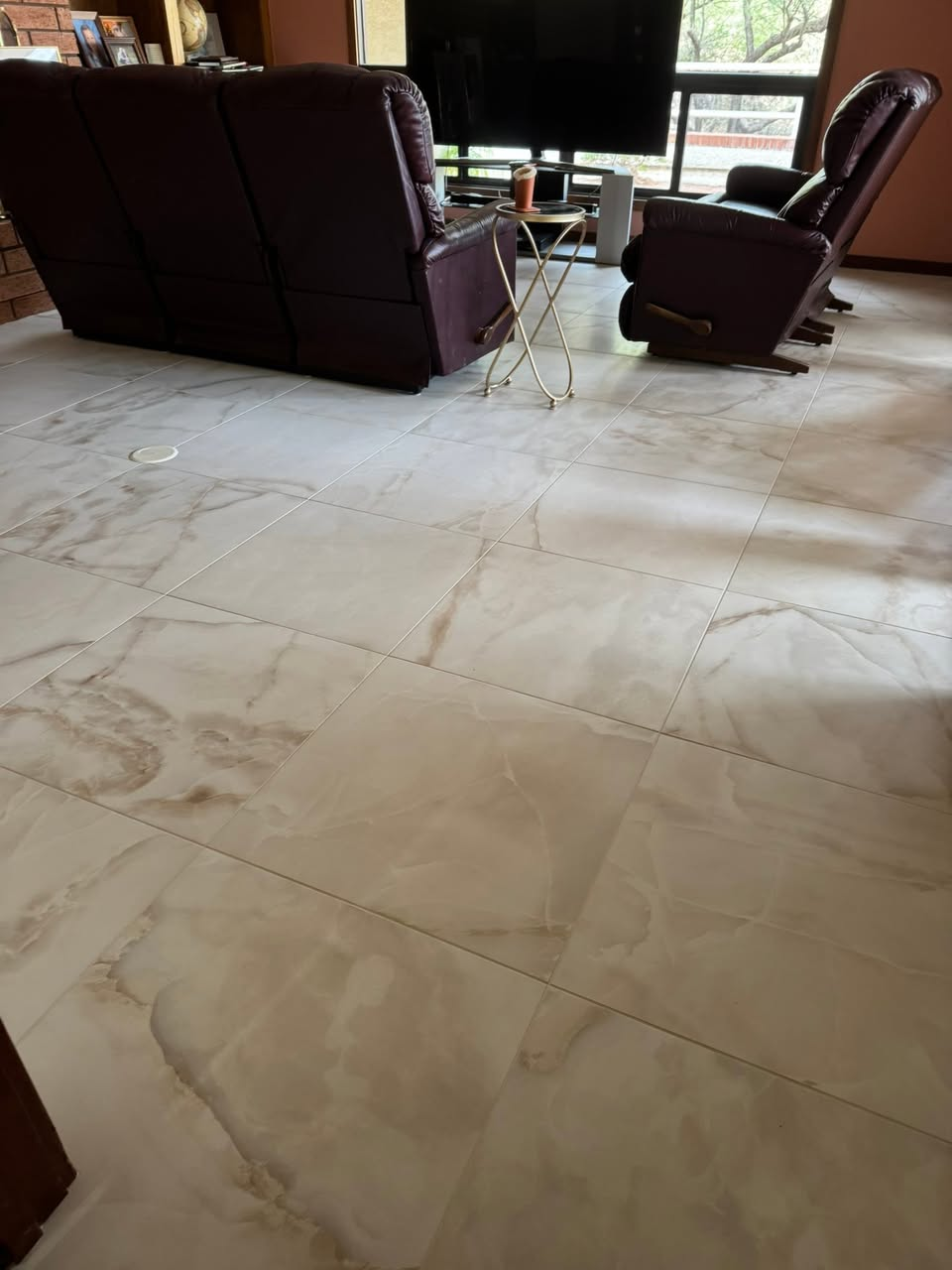 Large format marble-look porcelain tile in living room